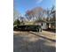 Back view of a single story home showing a driveway and carport at 1027 N Born Rd, Stone Mountain, GA 30088