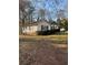 Side view of single story house featuring white siding at 1027 N Born Rd, Stone Mountain, GA 30088