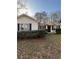 Charming single-story home with white siding, black shutters, and well-maintained landscaping at 1027 N Born Rd, Stone Mountain, GA 30088