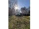 Street view of a house featuring lush green lawn and mature trees at 1027 N Born Rd, Stone Mountain, GA 30088