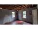 Bedroom needing renovation with exposed ceiling and damaged walls, windows providing natural light at 1182 Bronx Nw St, Atlanta, GA 30314