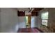 View of a distressed bedroom with peeling paint, damaged walls, ceiling fan, and exposed ceiling at 1182 Bronx Nw St, Atlanta, GA 30314