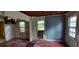 View of a distressed living room with peeling paint, damaged walls, and exposed ceiling at 1182 Bronx Nw St, Atlanta, GA 30314