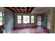 View of a distressed living room with peeling paint, damaged walls, exposed ceiling, and blue door at 1182 Bronx Nw St, Atlanta, GA 30314