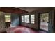 View of a damaged living room with hardwood floors, light blue walls, and a partially exposed ceiling at 1182 Bronx Nw St, Atlanta, GA 30314