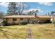 Backyard featuring brick home, open patio, and stone pathway at 1254 Renee Dr, Decatur, GA 30035