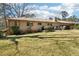 Home exterior with a brick facade, lush green yard and mature landscaping at 1254 Renee Dr, Decatur, GA 30035