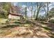 Backyard featuring a storage shed and sloped backyard surrounded by tall mature trees at 1254 Renee Dr, Decatur, GA 30035