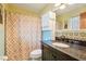 Bathroom featuring unique tile accents, a cabinet for storage, a dark vanity, and a shower curtain at 1254 Renee Dr, Decatur, GA 30035