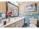 Bathroom featuring blue tile, a floral accent, a white vanity, a large mirror, and a toilet at 1254 Renee Dr, Decatur, GA 30035