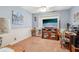 Functional bedroom featuring wood-look floor, wainscoting, and a TV mounted on the wall at 1254 Renee Dr, Decatur, GA 30035