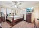 Traditional bedroom with carpet, wooden furniture, and a TV mounted on the wall at 1254 Renee Dr, Decatur, GA 30035