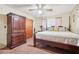 Bedroom featuring carpet, a ceiling fan, a four poster bed, a chest of drawers, and a closet at 1254 Renee Dr, Decatur, GA 30035