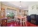 Dining room with vintage wallpaper, wood table, and view of the back yard at 1254 Renee Dr, Decatur, GA 30035