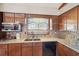 Bright kitchen featuring granite countertops, mosaic backsplash, and wooden cabinets at 1254 Renee Dr, Decatur, GA 30035