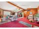 Spacious living room featuring wood paneling, ceiling fan, and comfortable leather furniture at 1254 Renee Dr, Decatur, GA 30035