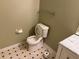 Bathroom with toilet and vanity featuring marble countertop and patterned floor at 1848 San Gabriel Ave, Decatur, GA 30032