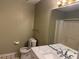 Bathroom features a toilet, marble countertop vanity with chrome fixtures, and a shower with curtain at 1848 San Gabriel Ave, Decatur, GA 30032