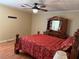 Bedroom with wooden floors, ceiling fan, and a bed with red floral bedding at 1848 San Gabriel Ave, Decatur, GA 30032