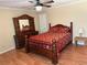 Bedroom with wooden floors, ceiling fan, and a bed with red floral bedding at 1848 San Gabriel Ave, Decatur, GA 30032