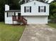 Charming split-level home with a two-car garage, a wood deck, and a well-maintained front yard at 1848 San Gabriel Ave, Decatur, GA 30032