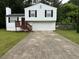 Charming split-level home with a two-car garage, a wood deck, and a well-maintained front yard at 1848 San Gabriel Ave, Decatur, GA 30032
