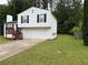Charming split-level home with a two-car garage, a wood deck, and a well-maintained front yard at 1848 San Gabriel Ave, Decatur, GA 30032