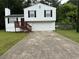 Charming split-level home with a two-car garage, a wood deck, and a well-maintained front yard at 1848 San Gabriel Ave, Decatur, GA 30032