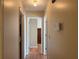 Hallway with neutral walls and view into another room with wood laminate floors at 1848 San Gabriel Ave, Decatur, GA 30032