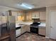 Cozy kitchen featuring stainless steel appliances, tile backsplash, and light wood cabinets at 1848 San Gabriel Ave, Decatur, GA 30032