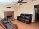 Cozy living room with a brick fireplace, ceiling fan, wood floor, and comfortable seating at 1848 San Gabriel Ave, Decatur, GA 30032