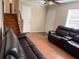 Open-concept living room featuring a ceiling fan, staircase, and laminate flooring at 1848 San Gabriel Ave, Decatur, GA 30032