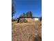 Exterior view of the brick home showcasing a wooden deck and spacious backyard at 2103 River Rd, Ellenwood, GA 30294