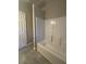 Bathroom featuring shower and tub combo with white walls at 2103 River Rd, Ellenwood, GA 30294