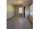 Bright bedroom featuring neutral walls, carpet, and multiple windows at 2103 River Rd, Ellenwood, GA 30294