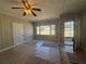 Cozy living room with paneled walls, bright windows, and ceiling fan at 2103 River Rd, Ellenwood, GA 30294