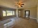 Inviting living room featuring carpet, neutral tones, a ceiling fan, and natural light at 2103 River Rd, Ellenwood, GA 30294