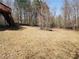 Expansive backyard with a gentle slope and sparse ground cover, offering potential for landscaping and recreation at 210 Vintage Dr, Covington, GA 30014