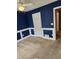 Bedroom featuring blue walls with white trim, light-colored carpet, and a ceiling fan at 210 Vintage Dr, Covington, GA 30014