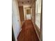 Hallway featuring hardwood floors and white trim with a front door and window at 210 Vintage Dr, Covington, GA 30014
