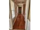 Hallway featuring hardwood floors and white trim with a front door and window at 210 Vintage Dr, Covington, GA 30014
