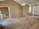 Open-concept living room featuring ceiling fan, light walls, and access to other rooms at 210 Vintage Dr, Covington, GA 30014
