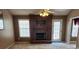 A living room with a dark fireplace, a ceiling fan, and views to the outdoor deck at 210 Vintage Dr, Covington, GA 30014
