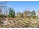 Expansive backyard with garden beds, mature trees, and ample space for outdoor activities at 4740 Union Hill Rd, Canton, GA 30115