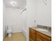 Well-lit bathroom featuring a single sink with a wooden cabinet and a toilet with shower and neutral tones at 4740 Union Hill Rd, Canton, GA 30115