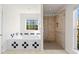 Bright bathroom featuring a tiled walk-in shower and a soaking tub with black and white accents at 4740 Union Hill Rd, Canton, GA 30115