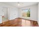 Sunlit bedroom with hardwood floors, double closets, and a large window offering a pleasant view at 4740 Union Hill Rd, Canton, GA 30115