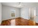 Light filled bedroom featuring hardwood floors, double door closet, and views from a large window at 4740 Union Hill Rd, Canton, GA 30115