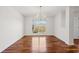 Bright dining room features hardwood floors, a chandelier, and a large window overlooking the yard at 4740 Union Hill Rd, Canton, GA 30115