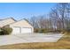 Long driveway leading to an attached garage, surrounded by mature trees and landscaping at 4740 Union Hill Rd, Canton, GA 30115